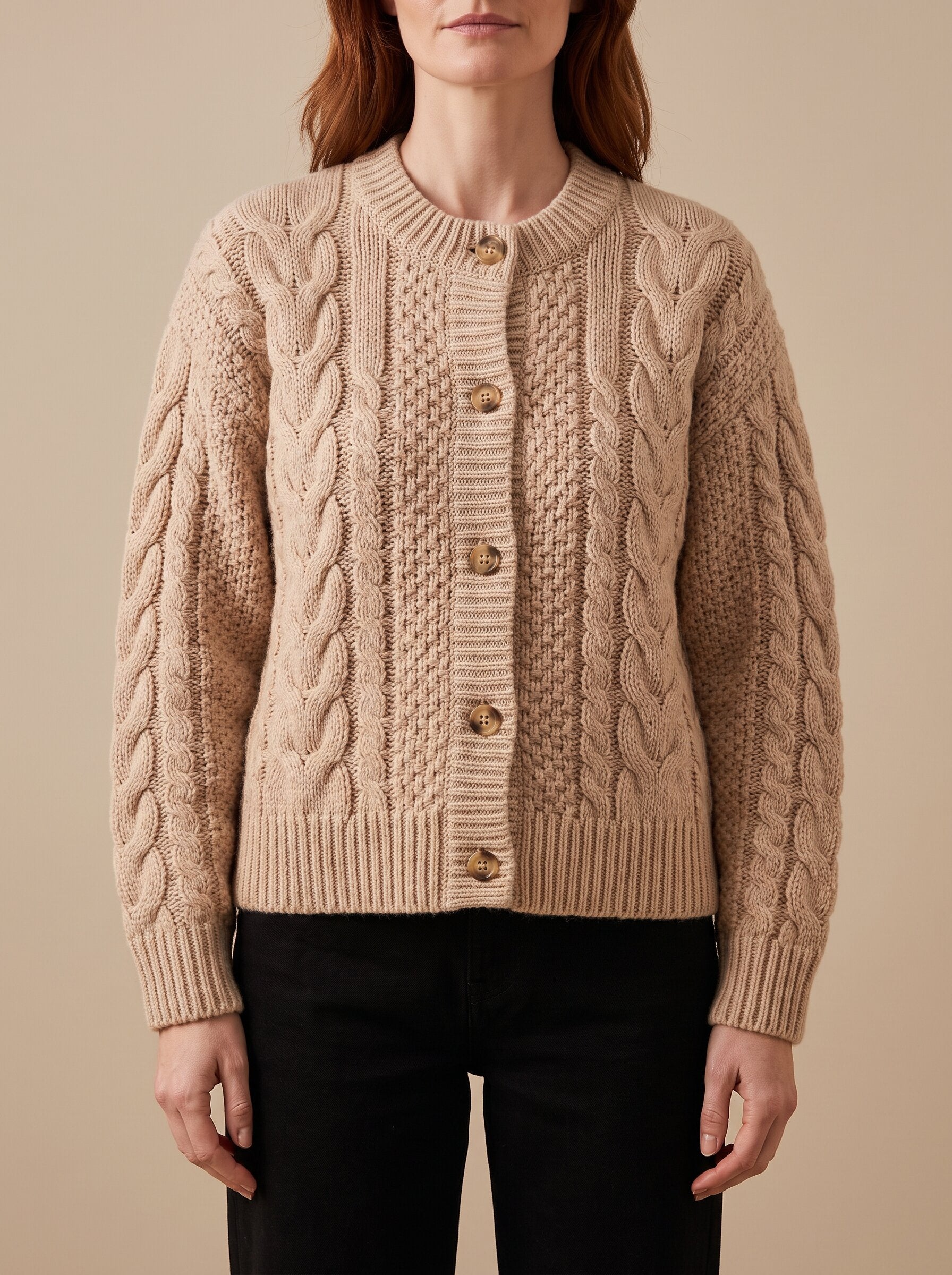 Women's chunky cable knit cardigan in beige, front view