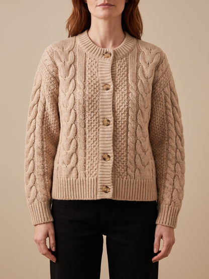 Women's chunky cable knit cardigan in beige, front view