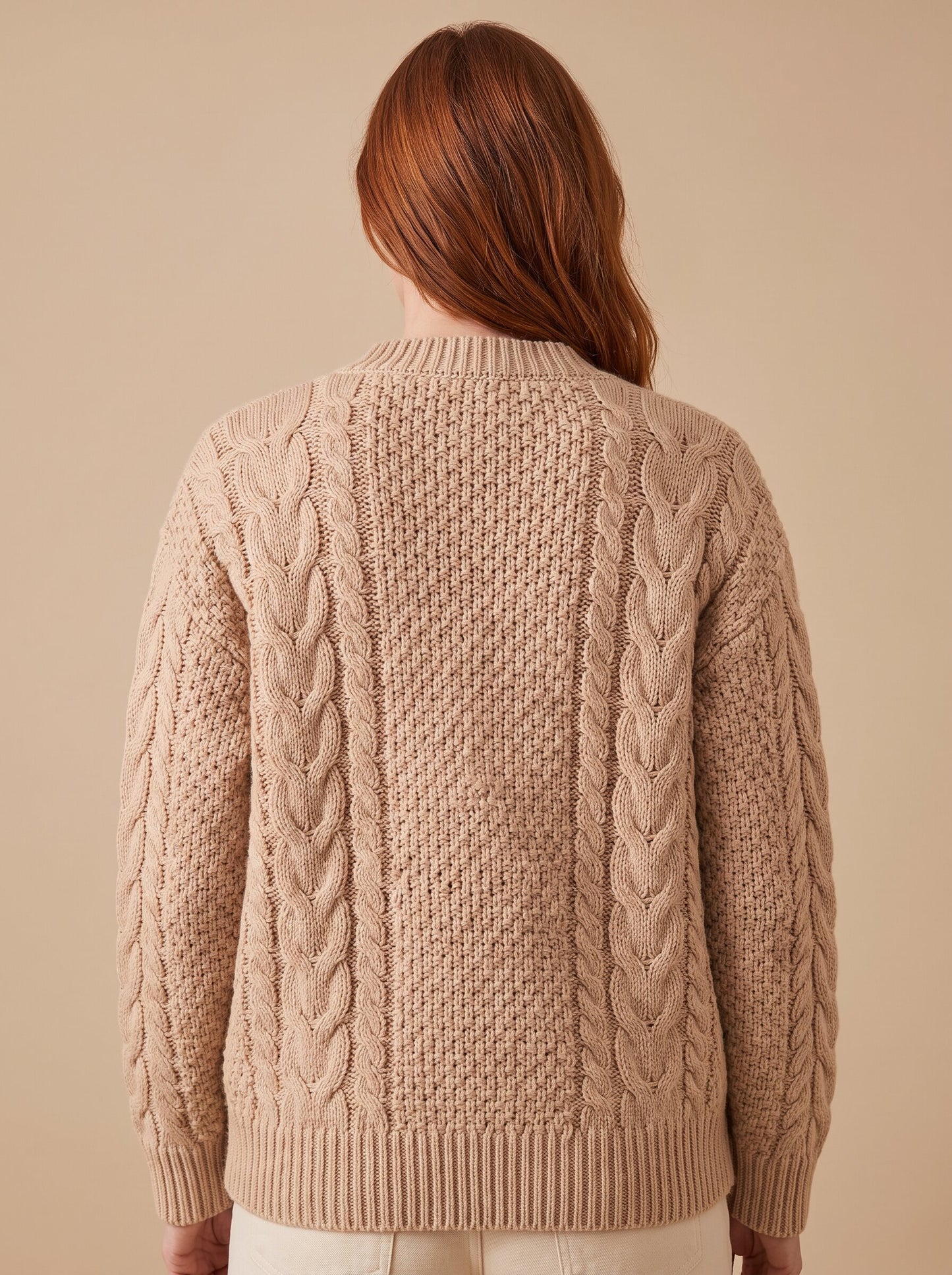 Women's chunky cable knit cardigan in beige, back view