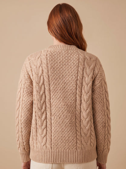 Women's chunky cable knit cardigan in beige, back view